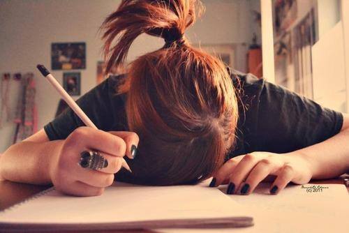 Girl stressed out studying with her head down